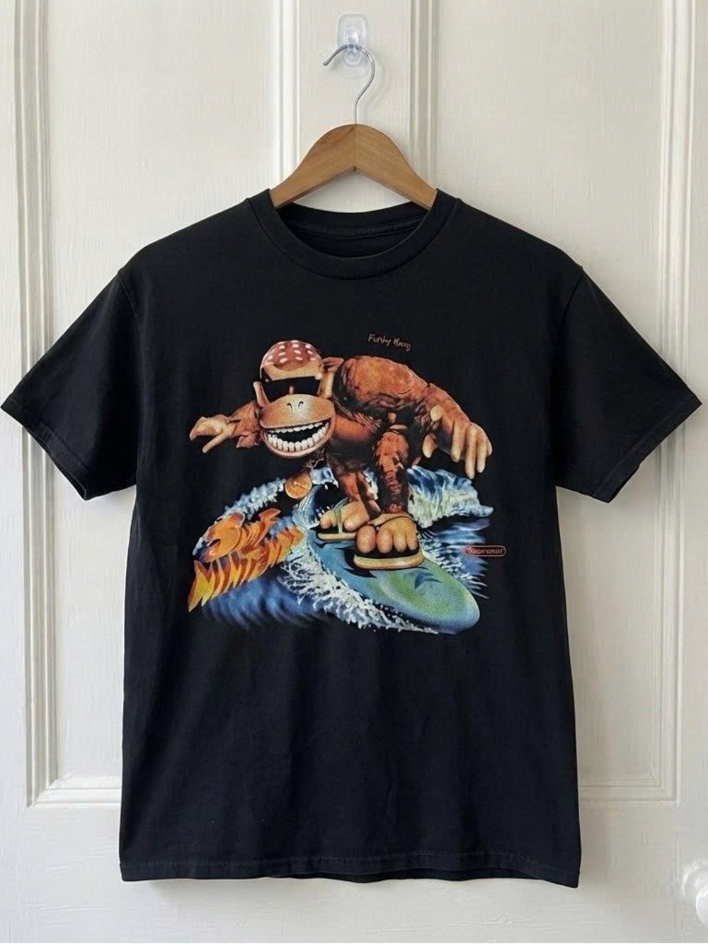 Vintage Black Tee with Vibrant Surfing Monster Graphic